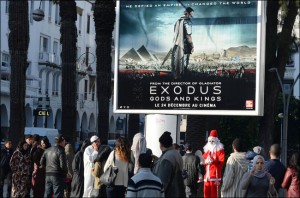 Moroccans walk past a billboard for the movie "Exodus" in Rabat on December 26th, 2014 [AFP/Fadel Senna] 