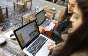 Two Turkish women try to get connected to Twitter with their laptops at a cafe in Istanbul amidst an Internet crackdown in the country in 2014. Should they be considered Internet addicts? (Tolga Bozoglu/EPA)