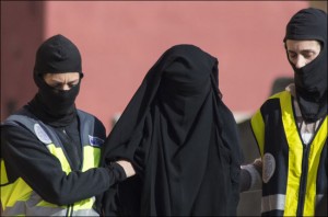 Spanish police on December 16th escort a woman arrested in Melilla during a joint operation with Morocco against Islamic State supporters [AFP/Jesus Blasco de Avellaneda]