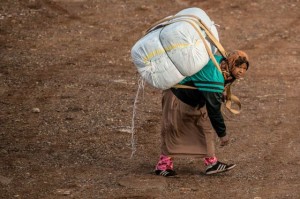 A Moroccan woman carries a large bale of goods on her back across the border from Spain into Morocco(David Ramos/Getty Images)