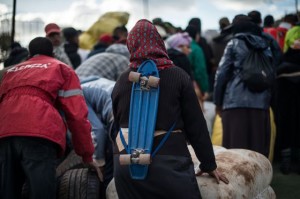 A Moroccan woman with a skateboard on her back waits to cross the border(David Ramos/Getty Images)