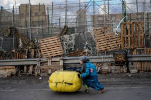 A Moroccan woman pushes a package on a skateboard(David Ramos/Getty Images)