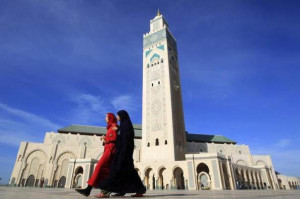 Moroccan women walk past the Hassan II mosque in Casablanca February 24, 2011. REUTERS/Pascal Rossignol