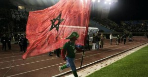 A supporter runs with a Moroccan flag during the sixth "Match against Poverty" in Fes