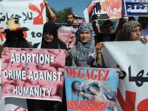 AFP/Getty Images Moroccan protesters hold slogans to protest against the abortion 