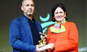 Festival Finale: Moroccan director Mohamed Mouftakir, left, receives from Tunisian Culture Minister Latifa Lakhdar the Golden Tanit award for his film “L’orchestre des aveugles” during the Carthage Film Festival on Saturday in Tunis (AFP)