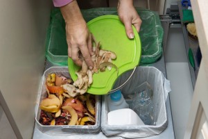 Household waste sorting and recycling kitchen bins in the drawer. Collecting food leftovers for composting. Environmentally responsible behavior, ecology concept.